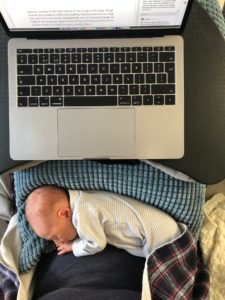 Baby girl sleeping in my lap whilst I work on the book